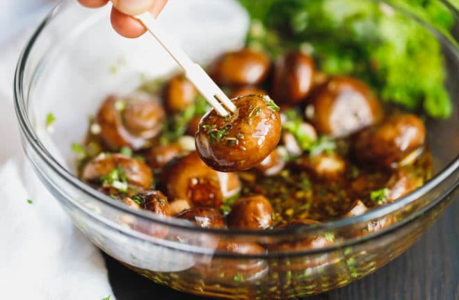 Marinated mushrooms on a wooden pick 