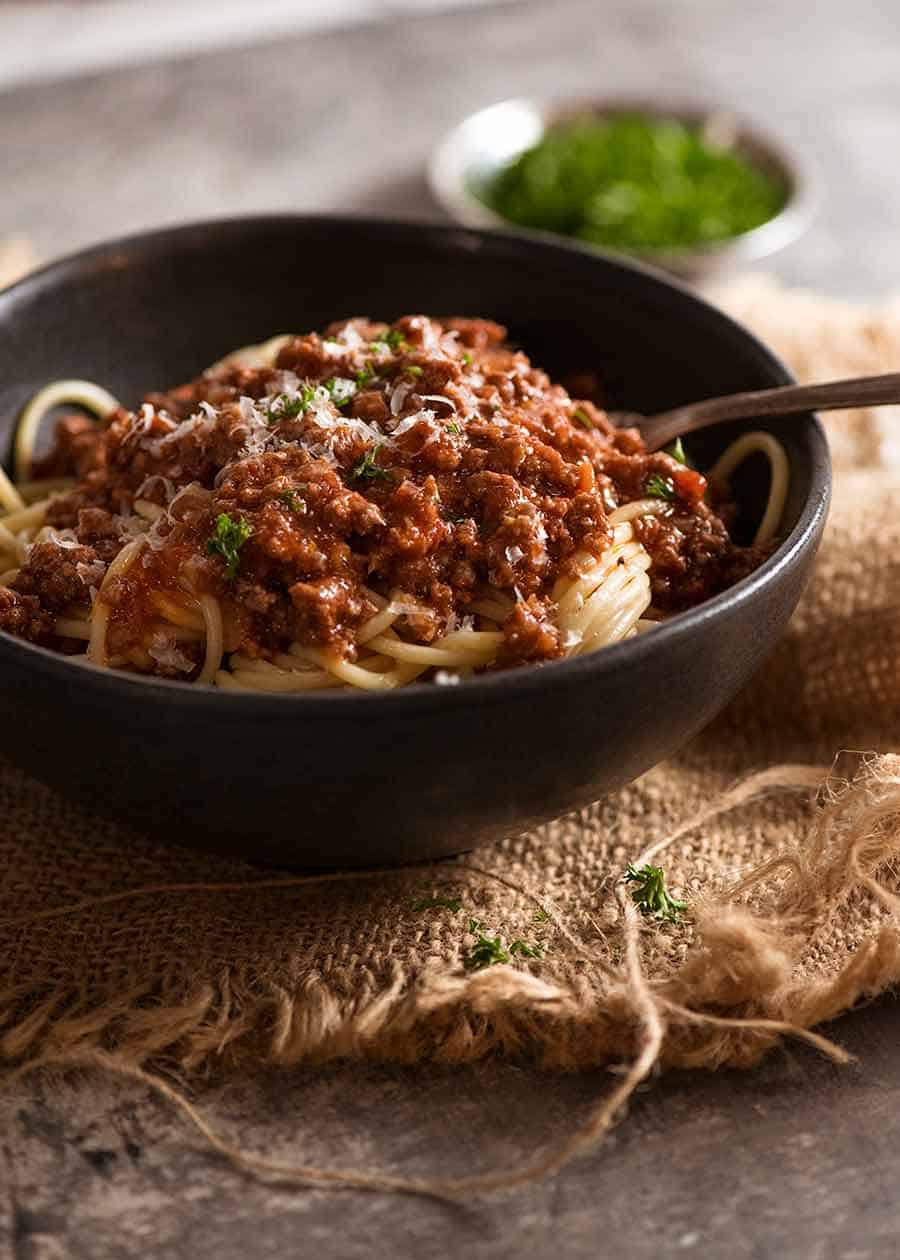 Meat sauce over spaghetti in a bowl, ready to be eaten